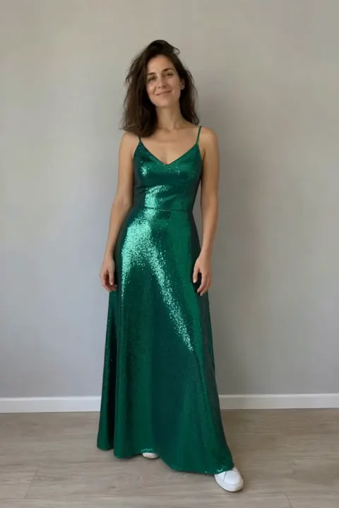 Actual Aisma result: The same turn in a floor-length emerald sequin gown.