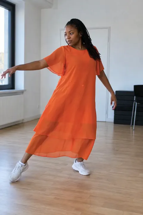 Actual Aisma result: Orange motion outfit on the same fifteen-second room dance. This is a complete real Aisma edit.